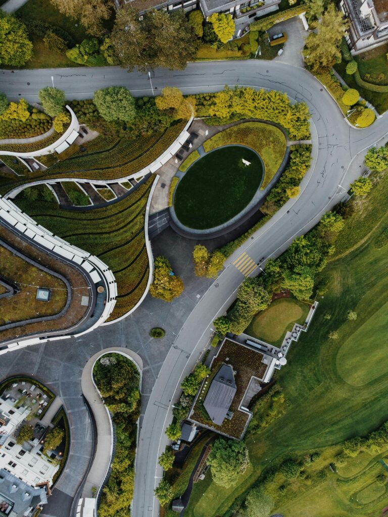 Stunning aerial shot showcasing green rooftops and winding roads.